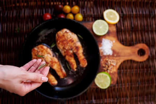 salting cooked steak in skillet